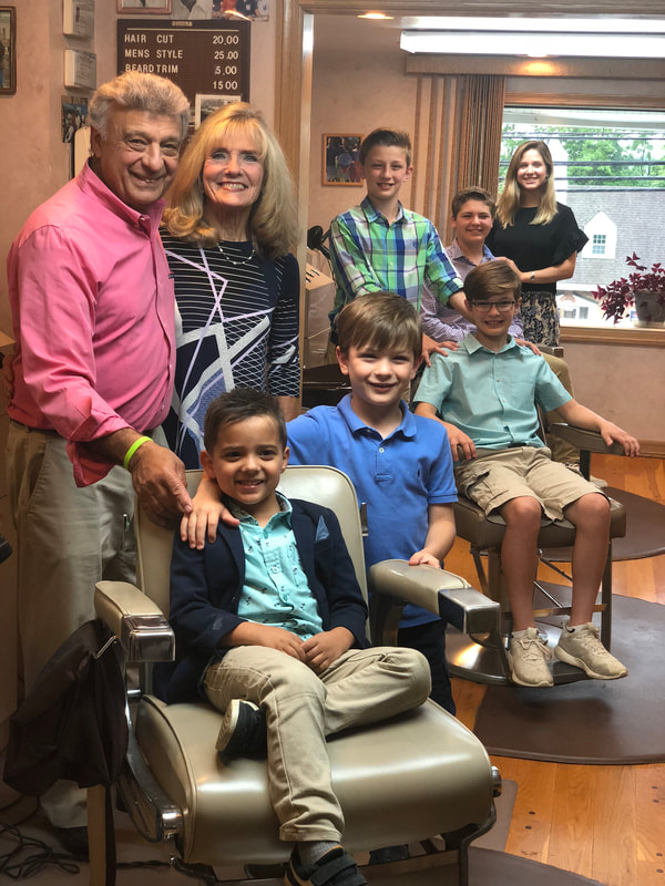 Sal and his wife with grandkids in Barber Shop
